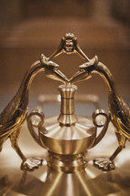 ornate top of a silver coffee pot