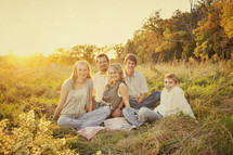 Happy family sitting in grass field