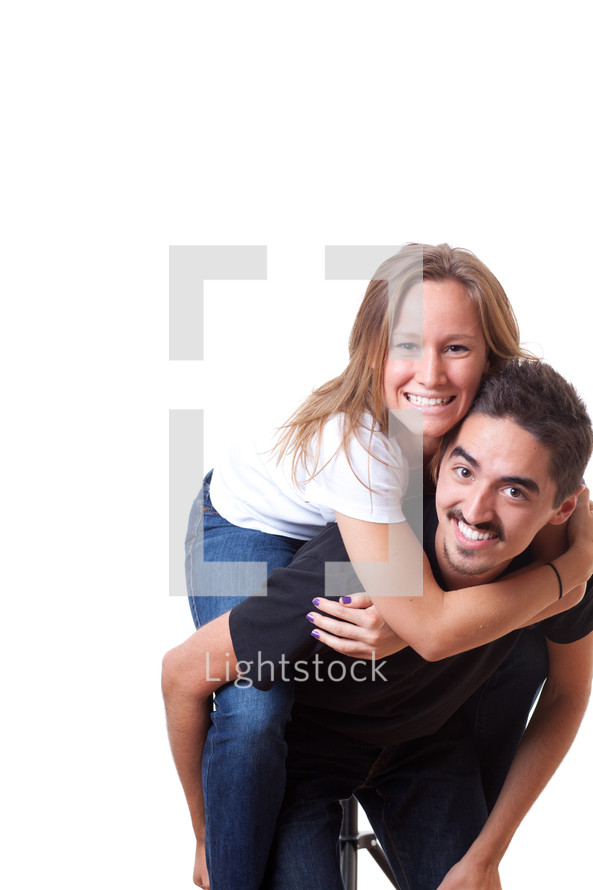 young woman riding piggy back on a man 