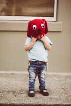 toddler boy in a red dog knit hat 