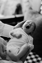 a newborn yawning 