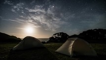 Camping in tent under stars sky in dark starry night Time lapse
