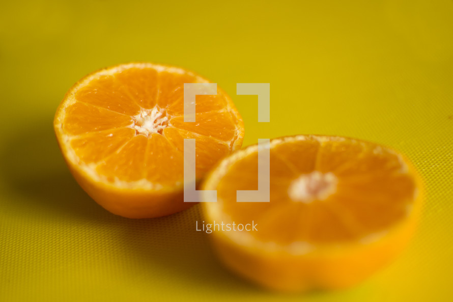 orange halves on yellow 