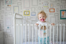 toddler girl in her crib 