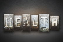 Stone tiles spelling the word HEALTH.