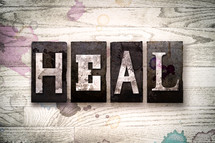 word heal on wood background 
