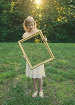 woman holding a mirror outdoors 