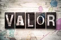 word valor on white washed wood