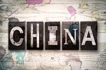 word China on white washed wood