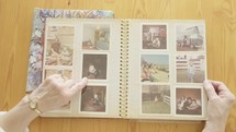 senior woman looking through a photo album 