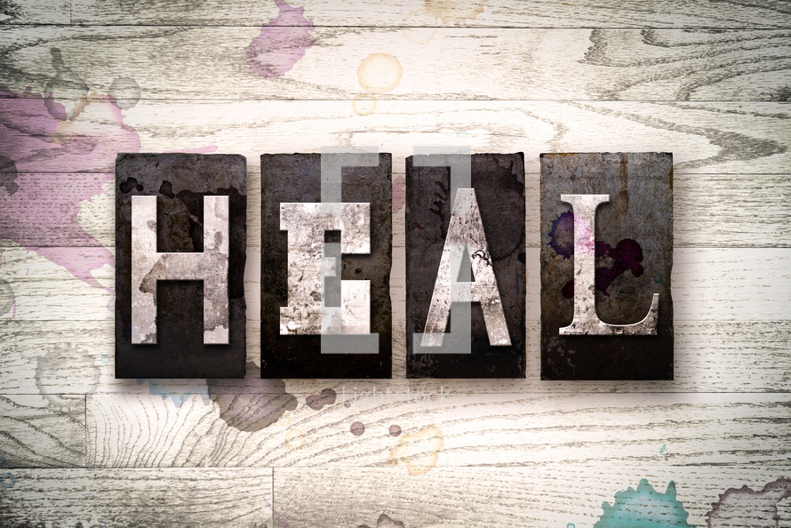 word heal on wood background 