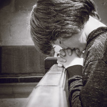 boy praying in a church 