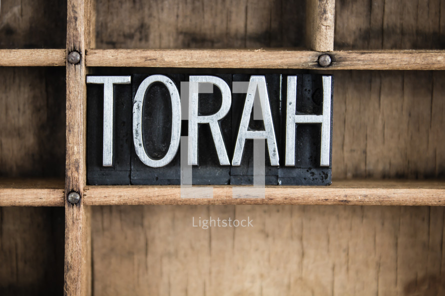 word Torah in blocks on a bookshelf 