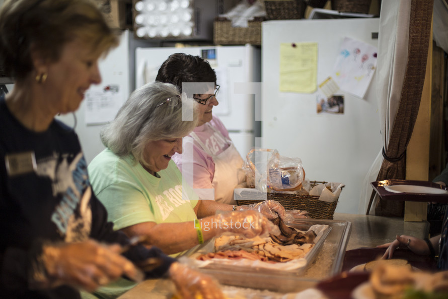 women in a church kitchen preparing food 