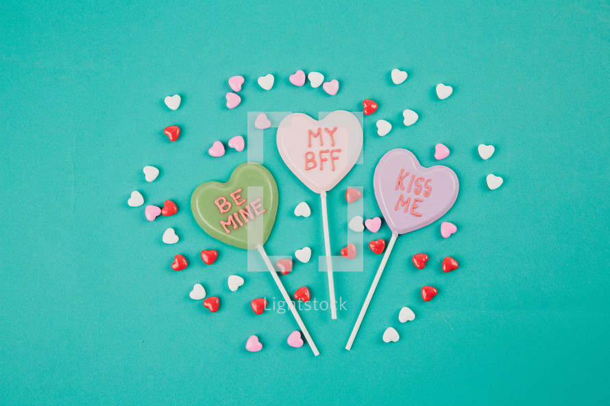 Small candy hearts surrounding Valentine candy hearts with Valentine messages.