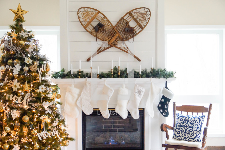 snowshoes over a fireplace and Christmas tree 