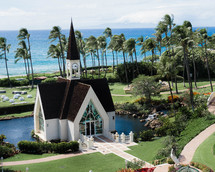 church surrounded by palm trees and ocean view 