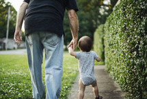grandfather and toddler holding hands 