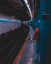 man standing in a subway tunnel 