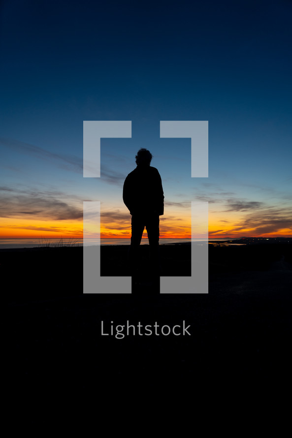silhouette of a man at dusk 