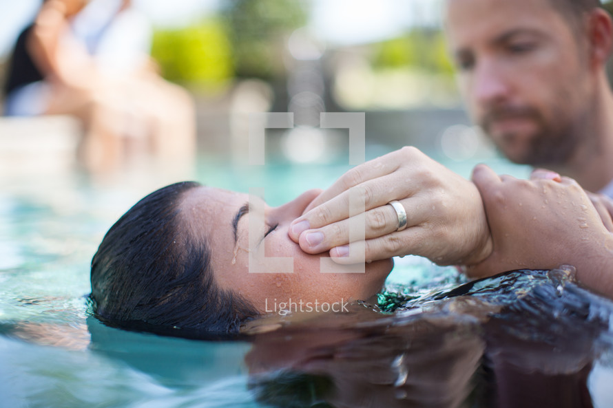 a woman being baptized in water 