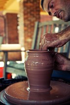 A potter molding a clay pot