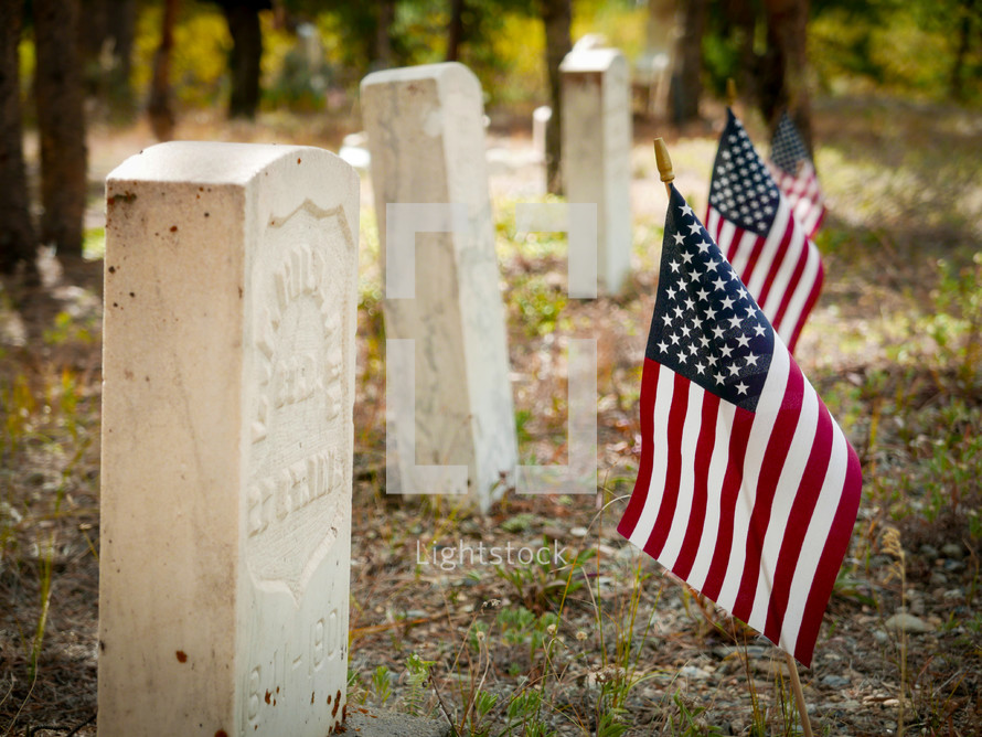 Memorial day, American flags beside very old grave markers, fallen but not forgotten