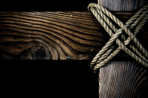 Wooden cross connected with rope
