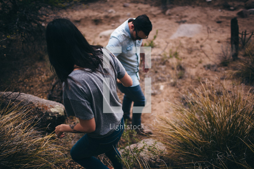 man and woman hiking outdoors 