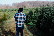 father and son at a Christmas tree lot 
