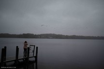 a woman standing on a dock 
