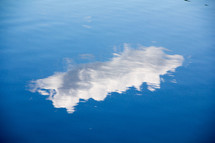 reflection of a cloud on lake water 
