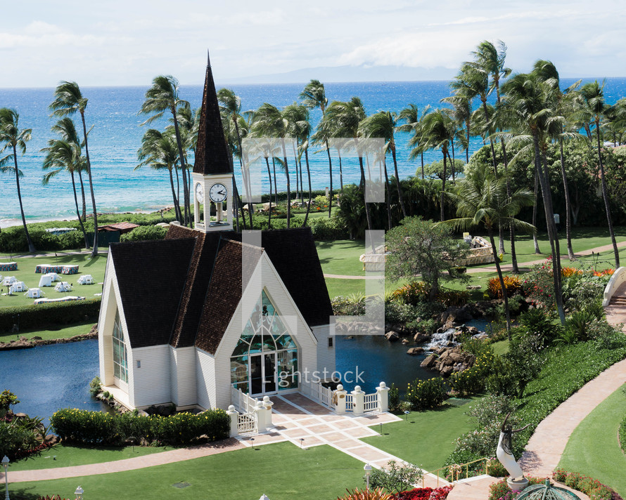 church surrounded by palm trees and ocean view 