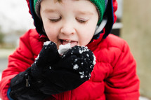 boy child eating snow 