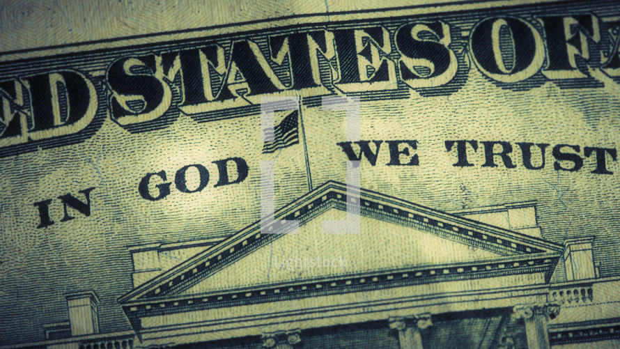 A close up of the phrase "In God We Trust" on a dollar bill