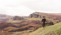 man standing on cliffs in Scotland 