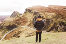 man standing on cliffs in Scotland 