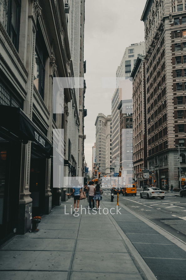 walking down a city sidewalk 