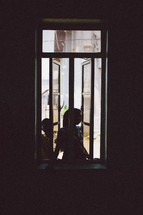 kids looking through a window in Nigeria 