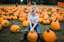 boy in a pumpkin patch 