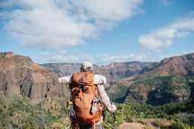 a man backpacking through a mountainous landscape 