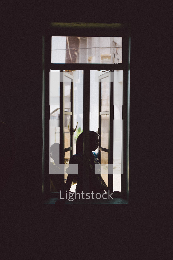 kids looking through a window in Nigeria 