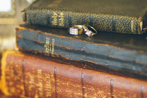 stack of Bibles and wedding rings 