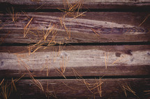 pine straw on wood boards 