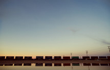 A train passing by carrying several cargo containers