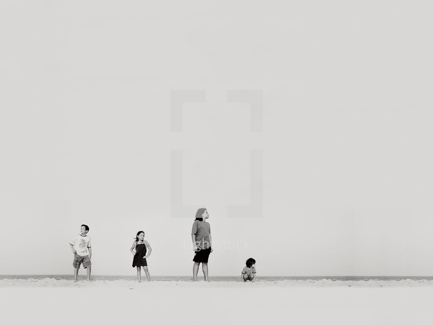 children standing and posing on a beach