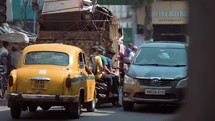 Cars and people on the streets of Kolkata, India.