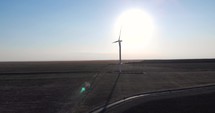 View Of Wind Turbine Generating Energy On A Sunny Day - drone shot