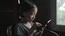 Girl holding a tablet with ear phones