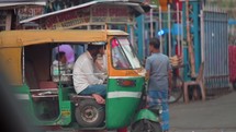 Yellow three-wheeled auto rickshaw taxi in Vizag Visakhapatnam, India.